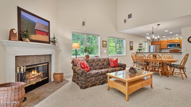 9074 Mountainside Dr, Hancock, MA 01237 - living room with light carpet, a chandelier, a tile fireplace, a towering ceiling, and baseboards