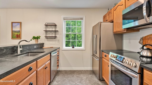 9074 Mountainside Dr, Hancock, MA 01237 - kitchen featuring stainless steel appliances, a sink, dark countertops, baseboards, and light tile patterned floors