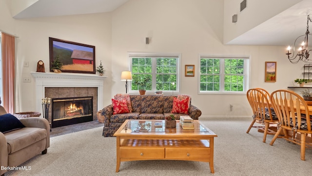 9074 Mountainside Dr, Hancock, MA 01237 - carpeted living area with a chandelier, a tiled fireplace, high vaulted ceiling, and baseboards