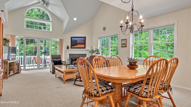 9074 Mountainside Dr, Hancock, MA 01237 - carpeted dining room with plenty of natural light, a ceiling fan, high vaulted ceiling, a fireplace, and a chandelier