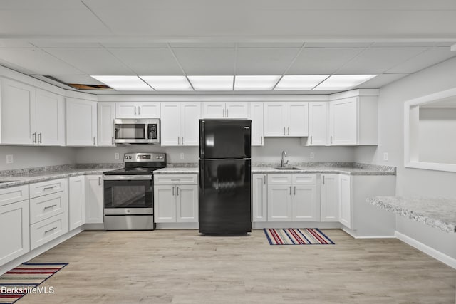 73 Narragansett Ave, Lanesborough, MA 01237 - kitchen with appliances with stainless steel finishes, a paneled ceiling, white cabinetry, light wood finished floors, and light stone countertops