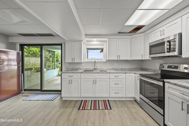 73 Narragansett Ave, Lanesborough, MA 01237 - kitchen featuring stainless steel appliances, a drop ceiling, light wood-type flooring, white cabinetry, and light stone countertops