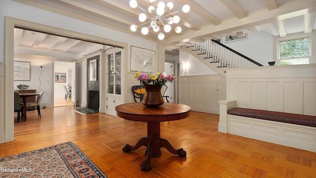 771 W Rd, Sheffield, MA 01257 - entryway with stairs, a chandelier, beam ceiling, wainscoting, and a decorative wall