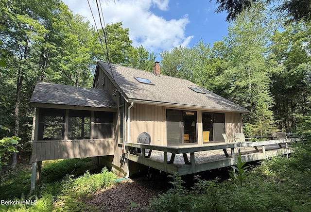 841 Moberg Rd, Becket, MA 01223 - back of property with roof with shingles, a sunroom, a deck, and a chimney