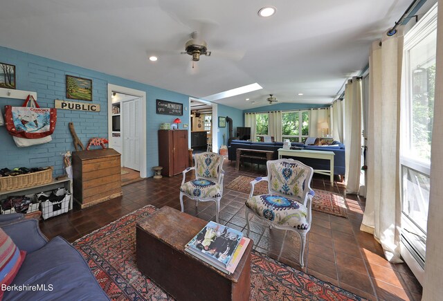 1 Train Hill Rd, Stockbridge, MA 01262 - living room with lofted ceiling with skylight, ceiling fan, and brick wall