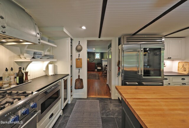 1 Train Hill Rd, Stockbridge, MA 01262 - kitchen with white cabinetry, beverage cooler, butcher block countertops, built in appliances, and exhaust hood