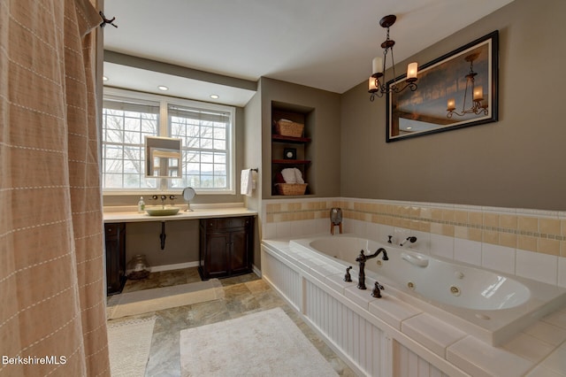 bathroom featuring a jetted tub and vanity