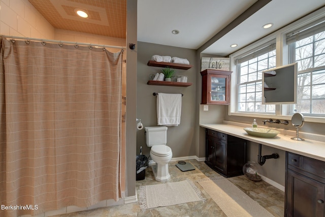 full bath featuring curtained shower, recessed lighting, vanity, and baseboards