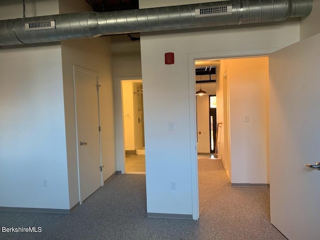hall with light colored carpet
