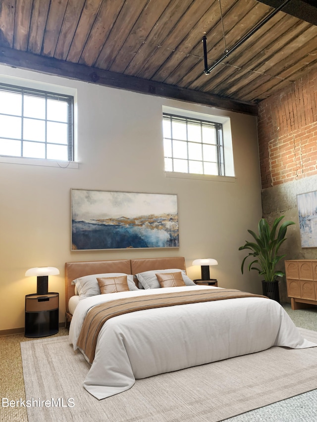 bedroom with light colored carpet and wood ceiling