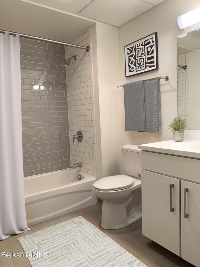 full bathroom featuring shower / bath combination with curtain, vanity, toilet, and tile patterned floors
