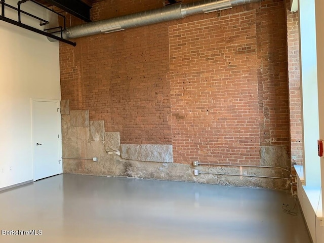basement with brick wall