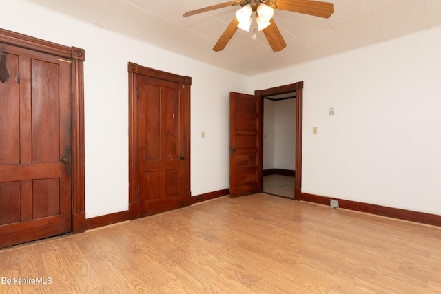 unfurnished bedroom with ceiling fan and light hardwood / wood-style floors