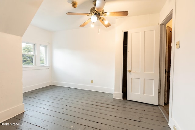 unfurnished room featuring ceiling fan and dark hardwood / wood-style floors