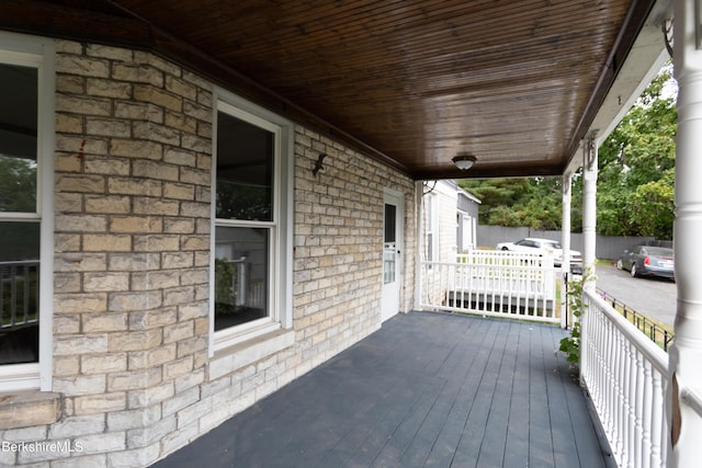 wooden terrace with a porch