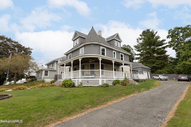 victorian-style house with a front yard and a porch