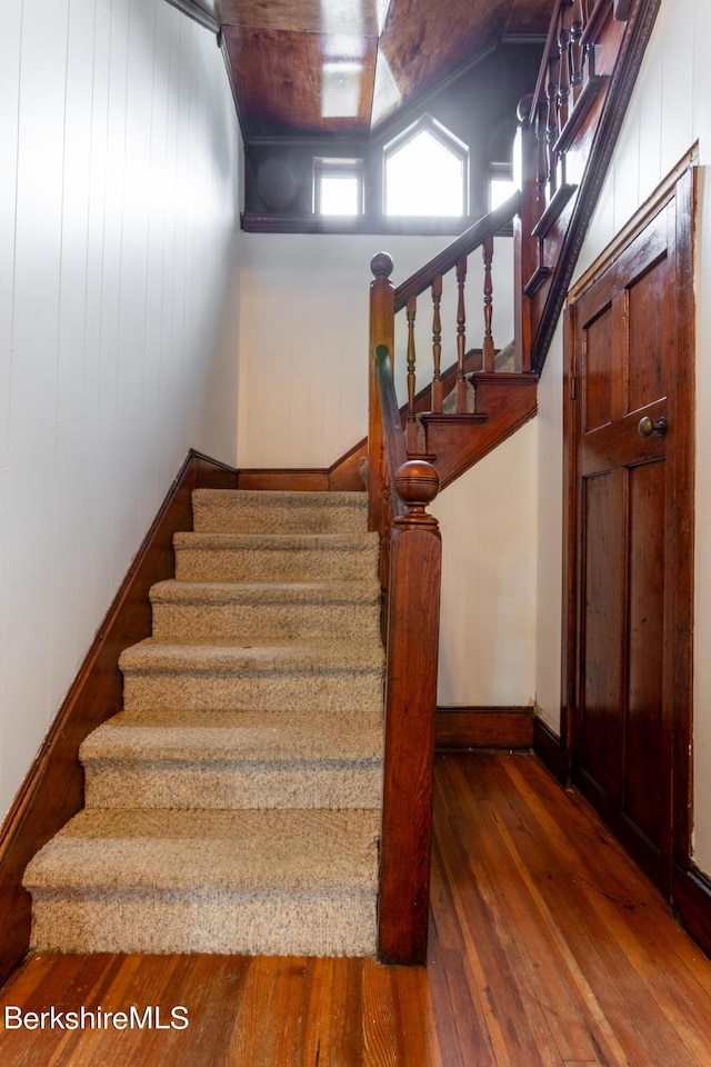 staircase with hardwood / wood-style flooring