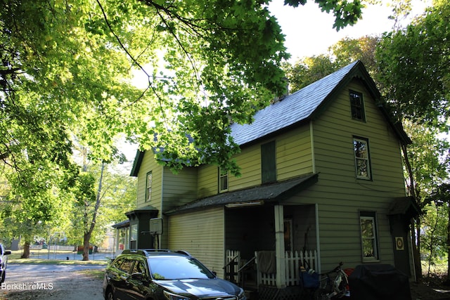 view of property exterior with a porch