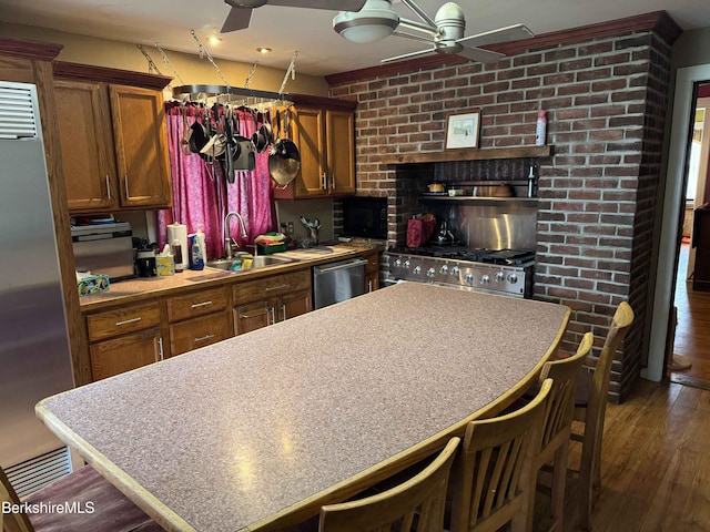 145 Bartlett Ave, Pittsfield, MA 01201 - kitchen with a ceiling fan, a sink, stainless steel appliances, dark wood-style flooring, and brown cabinetry