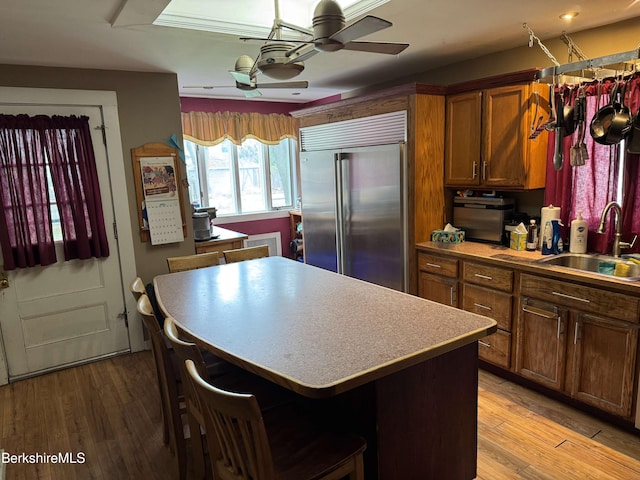 145 Bartlett Ave, Pittsfield, MA 01201 - kitchen featuring a sink, built in refrigerator, a kitchen island, a ceiling fan, and brown cabinets