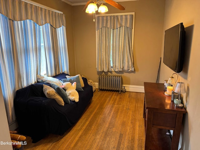145 Bartlett Ave, Pittsfield, MA 01201 - living area with radiator, ceiling fan, baseboards, wood finished floors, and ornamental molding
