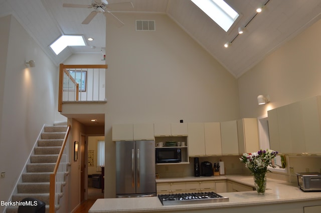 345 Big Bass Ln, Becket, MA 01223 - kitchen featuring a skylight, appliances with stainless steel finishes, high vaulted ceiling, light countertops, and a ceiling fan