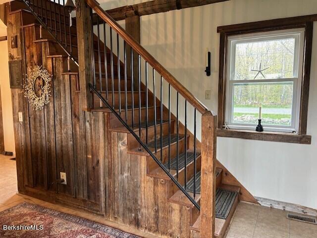 stairs with tile patterned floors