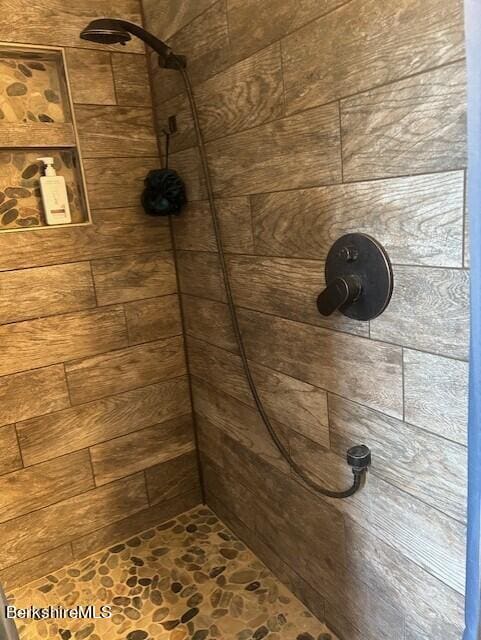 bathroom with a tile shower