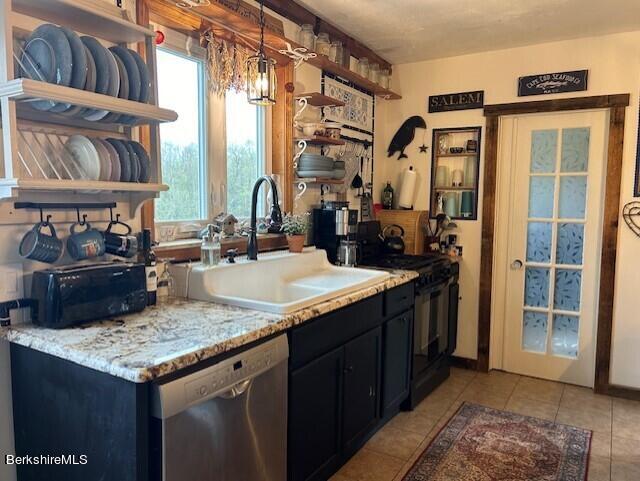 kitchen with dishwasher, sink, electric range, light stone countertops, and light tile patterned floors