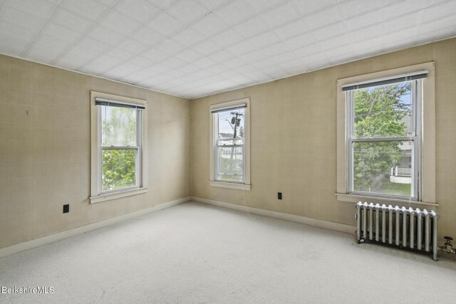 232 First St, Pittsfield, MA 01201 - unfurnished room featuring radiator heating unit, carpet floors, and baseboards
