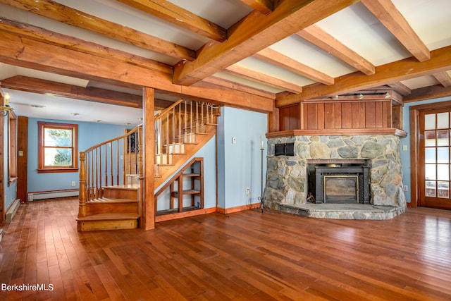 1151 Hancock Rd, Williamstown, MA 01267 - unfurnished living room featuring baseboard heating, hardwood / wood-style floors, beamed ceiling, stairs, and a stone fireplace