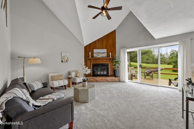 94 Corey Rd Unit D, Hancock, MA 01237 - living room featuring high vaulted ceiling, carpet, a ceiling fan, and a fireplace