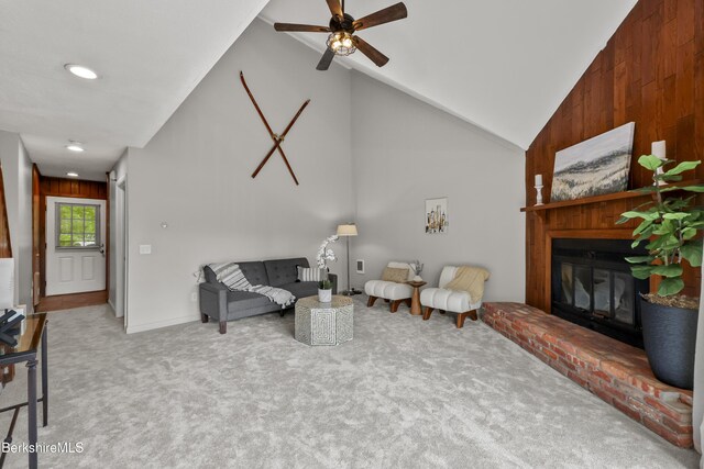 94 Corey Rd Unit D, Hancock, MA 01237 - carpeted living room with vaulted ceiling, ceiling fan, a fireplace, recessed lighting, and wood walls