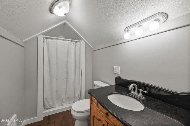 94 Corey Rd Unit D, Hancock, MA 01237 - bathroom featuring a textured ceiling, vaulted ceiling, wood finished floors, toilet, and curtained shower