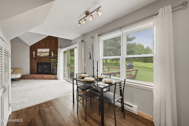 94 Corey Rd Unit D, Hancock, MA 01237 - dining room featuring wood finished floors, a glass covered fireplace, lofted ceiling, and a baseboard radiator