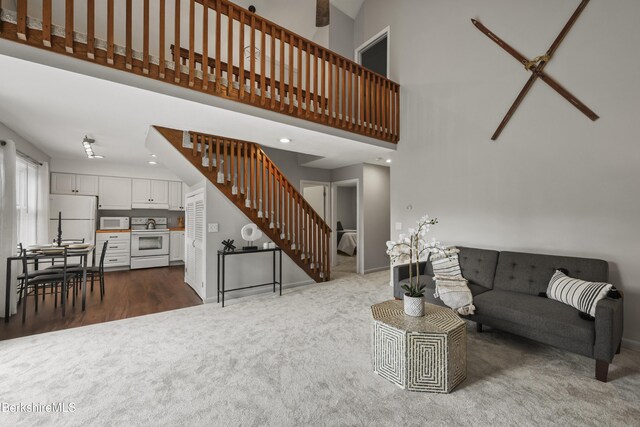 94 Corey Rd Unit D, Hancock, MA 01237 - carpeted living area featuring stairway, a high ceiling, baseboards, and recessed lighting