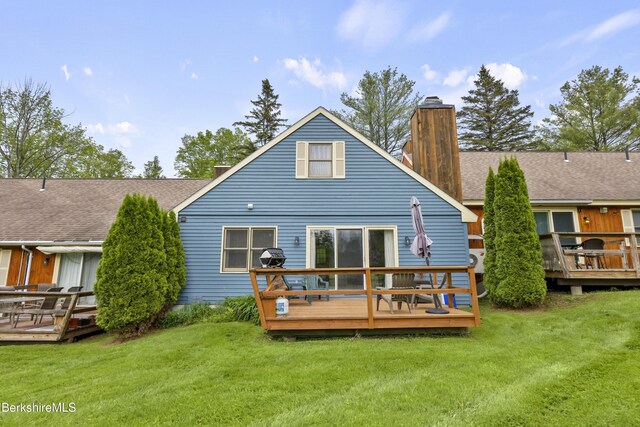 94 Corey Rd Unit D, Hancock, MA 01237 - rear view of property featuring a chimney, a wooden deck, and a lawn