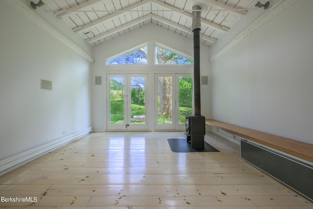 unfurnished living room featuring a wood stove, high vaulted ceiling, light wood-type flooring, beam ceiling, and wood ceiling