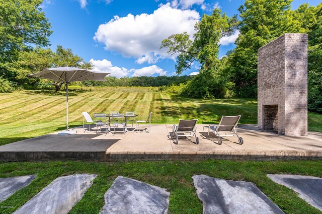 view of community featuring a patio area and a lawn