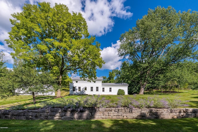 rear view of house featuring a lawn