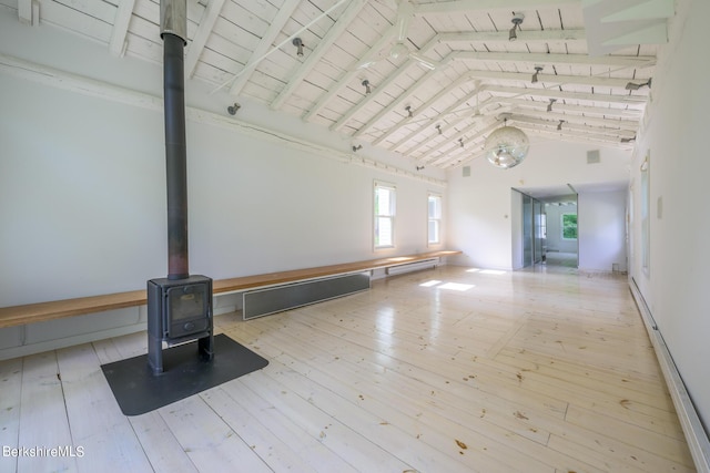 interior space featuring light wood-type flooring, baseboard heating, high vaulted ceiling, wooden ceiling, and a wood stove