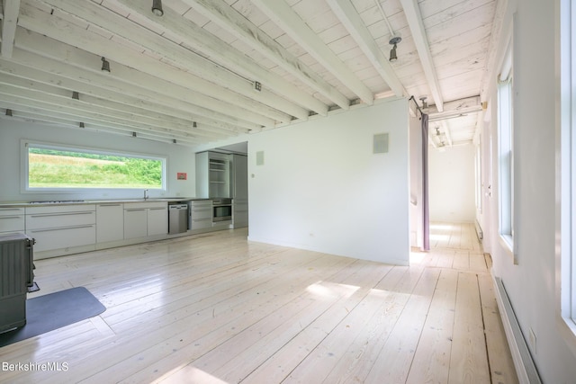 unfurnished living room featuring beamed ceiling, light hardwood / wood-style floors, wooden ceiling, and sink