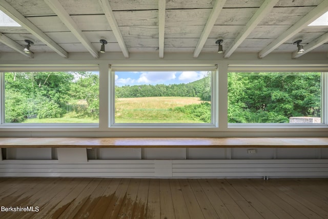 unfurnished sunroom with beamed ceiling and wood ceiling