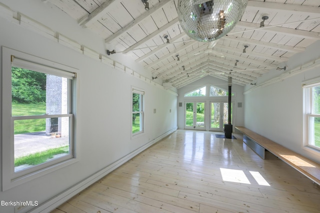 empty room with light hardwood / wood-style floors, beam ceiling, wood ceiling, and french doors