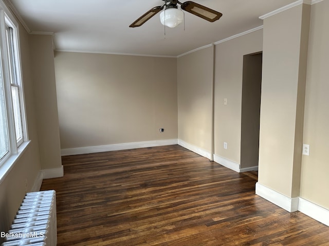 spare room featuring radiator, crown molding, dark wood-type flooring, and ceiling fan