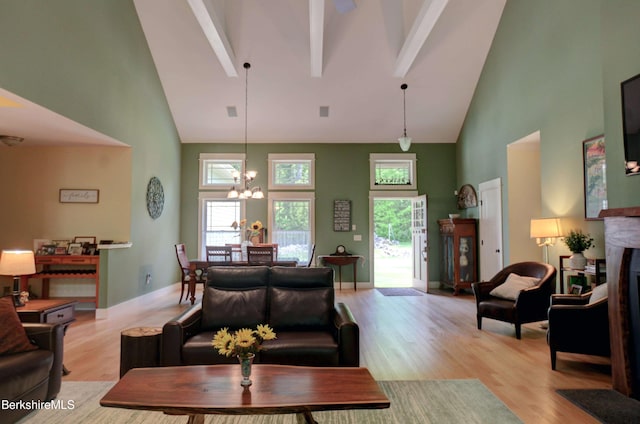 7 Perry Rd, Sandisfield, MA 01255 - living area with high vaulted ceiling, a chandelier, beamed ceiling, light wood finished floors, and a fireplace