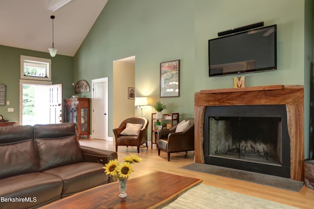 7 Perry Rd, Sandisfield, MA 01255 - living area with high vaulted ceiling, wood finished floors, and a fireplace with flush hearth