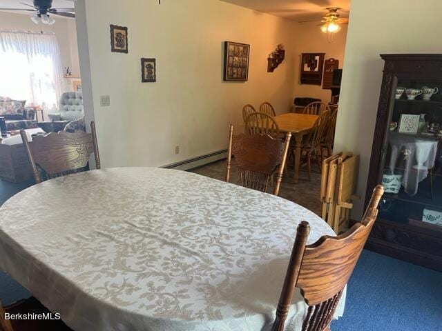 dining space with ceiling fan, a baseboard radiator, and dark carpet
