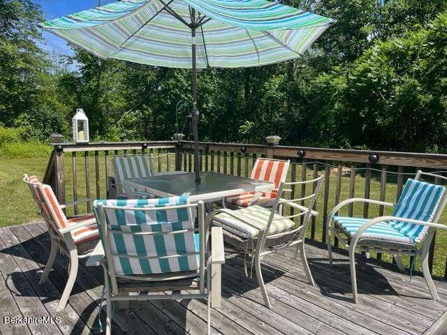 wooden terrace with a lawn