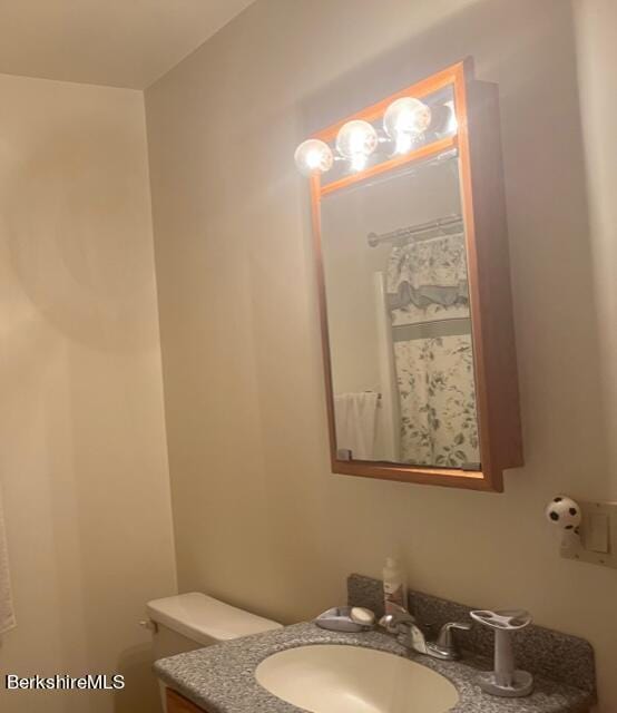 bathroom featuring vanity and toilet